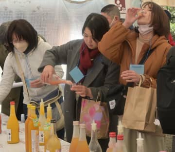 全国から集まった梅酒の飲み比べをする来場者たち=水戸市常磐町