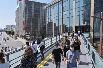 水戸市民会館(右)と京成百貨店をつなぐ上空通路を行き交う人たち=2日午後、同市泉町