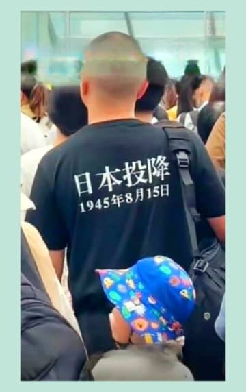 終戦の日の8月15日、中国の駅で「日本投降」の文字が書かれたTシャツを着た男性がいた。