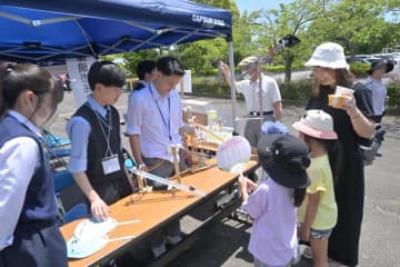 風力発電の実験を楽しむ家族連れ=那珂市福田